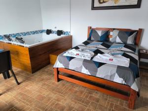 a bedroom with a bed and a bath tub at Hotel Palmarito in Tauramena
