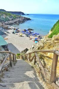 a beach with umbrellas and people on the beach at Casa Bianca in Iglesias