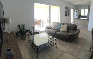 a living room with a couch and a glass table at U capannellu in Calcatoggio