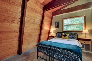 a bedroom with a bed in a room with wooden walls at Rhododendron Family Cabin Hot Tub and Deck! in Rhododendron +27 photos