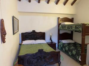 a bedroom with two bunk beds in a room at Casa Boyero de Berna Campestre in Villa de Leyva +6 photos
