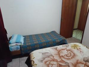 a room with two beds and a mirror at Apart la hermosa in Puerto Iguazú +10 photos