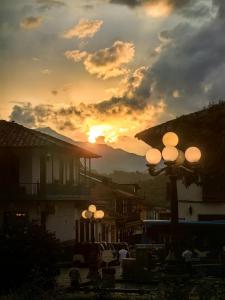 a sunset with a group of street lights in a town at Hotel Colonial in Jardin