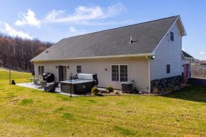 a white house with a large grass yard at Deep Creek Retreat Hot Tub 85 inchTV all one level in Accident