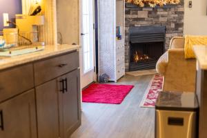 a kitchen with a living room with a fireplace at Deep Creek Retreat Hot Tub 85 inchTV all one level in Accident +94 photos