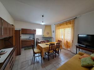 a kitchen and dining room with a table and chairs at Da "Zia Giovanna" in San Giovanni Suèrgiu +11 photos