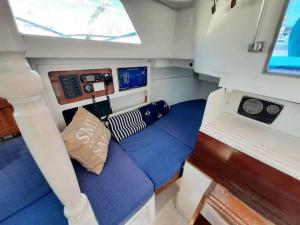 a small boat with a bed in the back of it at Vintage sailboat experience in Lisbon
