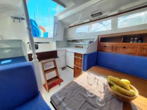 a kitchen with a table with glasses and bananas on it at Vintage sailboat experience in Lisbon