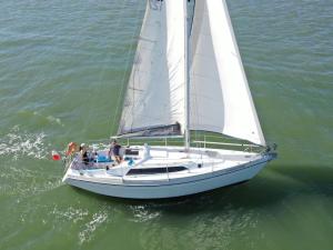 a group of people on a sailboat in the water at Vintage sailboat experience in Lisbon +11 photos