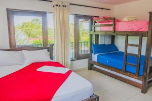 a bedroom with bunk beds and a balcony at Finca Casa Blanca in Armenia +27 photos