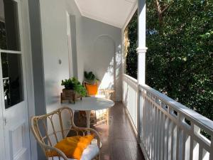 a balcony with a table and chairs on a porch at Light filled terrace flat in Sydney