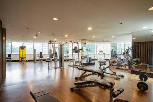a gym with several treadmills and exercise machines at Premium 1BR unit at The Avant in Manila