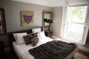 a bedroom with a bed with pillows and a window at Apartment 88 in Greytown
