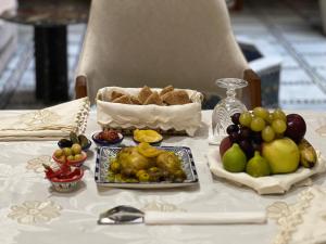 a table with a plate of fruit on it at Riad Safia in Rabat