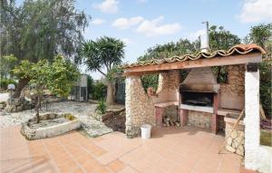 a stone fireplace in a yard with a patio at Gorgeous Home In Vittoria With Wifi in Vittoria