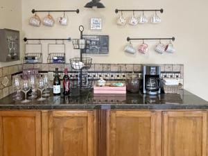 a kitchen with a counter with wine glasses on the wall at Beaver Lake Getaway in Rogers