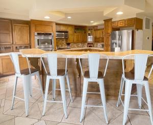 a kitchen with a table and four stools at Beaver Lake Getaway in Rogers