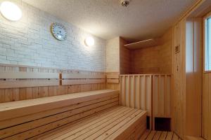 a sauna with a clock on a brick wall at Shogetsu Grand Hotel in Jozankei +45 photos