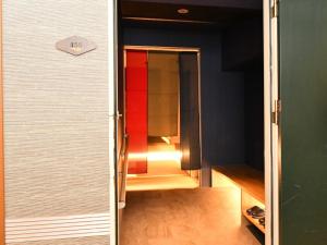 an open door of an empty refrigerator in a room at Nagasaki Sky Hotel in Nagasaki