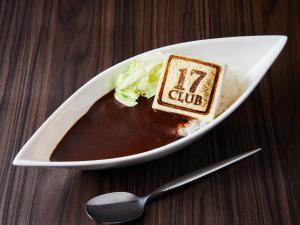 a white plate with a piece of cake and a spoon at APA Hotel & Resort Osaka Namba Ekimae Tower in Osaka