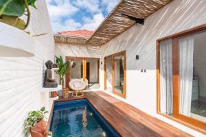 a house with a swimming pool in the backyard at Senna Villa - 2BR with Private Pool in Canggu