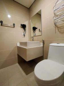 a bathroom with a white toilet and a sink at Boracay Condo 1, Ocean Garden Villa Boracay Newcoast in Boracay