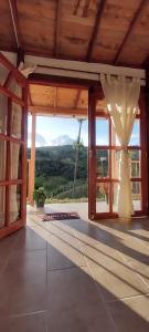 a room with a large glass door with a view at Ancestral Cabaña in San Vicente