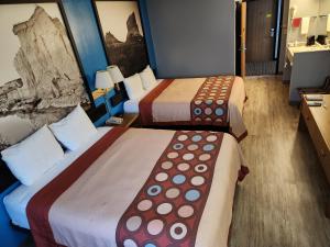 a hotel room with two beds and a bathroom at Super Star Inn & Suite Lincoln Crete in Crete