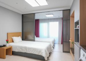 Postel nebo postele na pokoji v ubytování Firstcity Hotel YEOSU