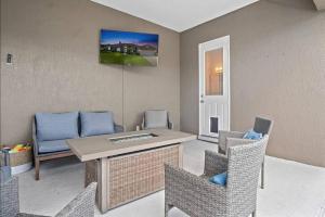 a living room with a table and chairs at Luxury Heated Pool Home, Hot tub, King bed suite in Lakeland