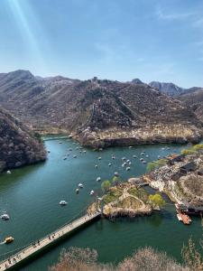 an aerial view of a river with boats in it at Beijing Wuji Inn - The Great Wall of China Huanghuacheng in Beijing