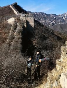 a man and a child standing on a hill at Beijing Wuji Inn - The Great Wall of China Huanghuacheng in Beijing