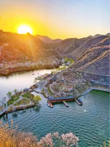 an aerial view of a river at sunset at Beijing Wuji Inn - The Great Wall of China Huanghuacheng in Beijing