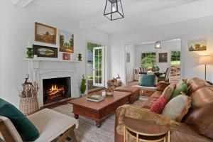 a living room with a couch and a fireplace at The Croft - Enchanting Bowral stone cottage in Bowral