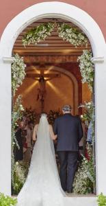 a man and a bride walking down a aisle at Hacienda Santa Cruz Merida in Mérida +145 photos