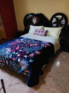 a bedroom with a bed with a black headboard at Residence Dayet Aoua in Ifrane +1 photo
