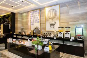 a restaurant with a counter with food on it at Boda Hotel in Taichung