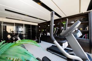 a fitness room with a gym with a treadmill at Boda Hotel in Taichung