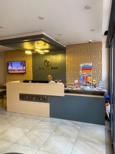 a man sitting at a counter in a restaurant at Otel Yenikapı in Istanbul