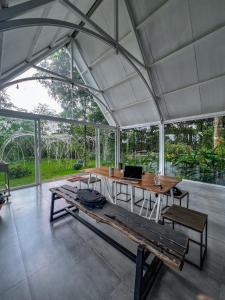 a large tent with a table with a laptop on it at MeGarden Daknong in Gia Nghĩa