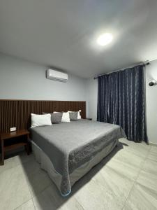 a bedroom with a large bed and a window at Hotel Santa María Inn in San Juan de los Lagos