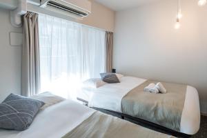 Krevet ili kreveti u jedinici u okviru objekta Apartment Hotel 11 Shinsaibashi