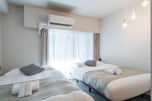 Krevet ili kreveti u jedinici u okviru objekta Apartment Hotel 11 Shinsaibashi