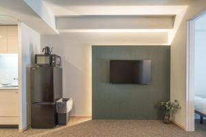 TV i/ili multimedijalni sistem u objektu Apartment Hotel 11 Shinsaibashi