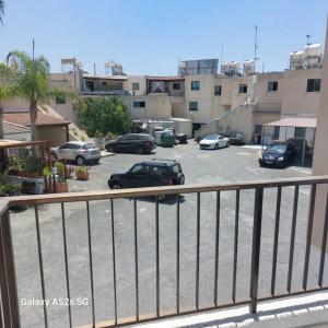 a parking lot with cars parked in a parking lot at Irenes Apartment in Larnaca