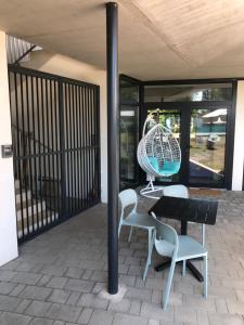 a table and chairs and a globe on a patio at Portside Apartman in Tihany