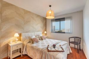 a bedroom with a bed and a table and a chair at Apartamento Vista Paraiso in Adeje +21 photos
