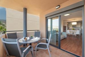 a dining room with a table and chairs on a balcony at Apartamento Vista Paraiso in Adeje