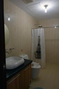 a bathroom with a sink and a toilet and a shower at BALAI Condominiums in Lusong