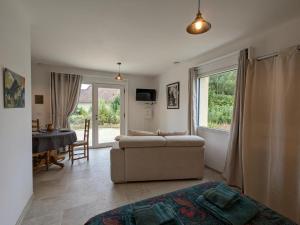 a living room with a couch and a table at Studio moderne avec terrasse, parking et WIFI - FR-1-653-262 in Baignes-Sainte-Radegonde